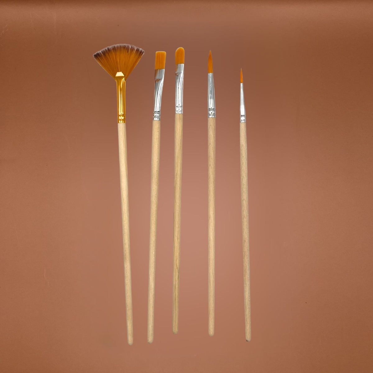 Five paint brushes with light wood handles and orange bristles, arranged vertically against a solid warm brown background.