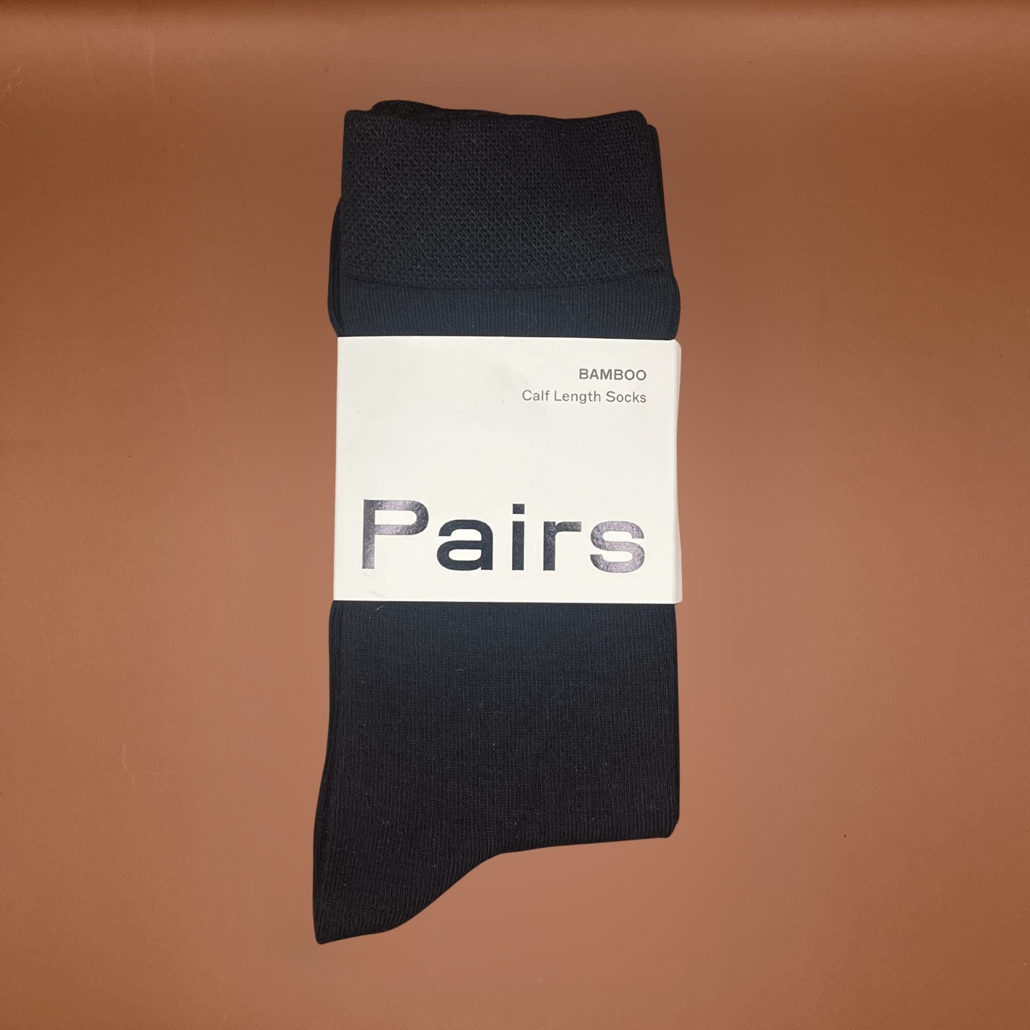 Pair of black socks with 'Pairs' branding on white card packaging