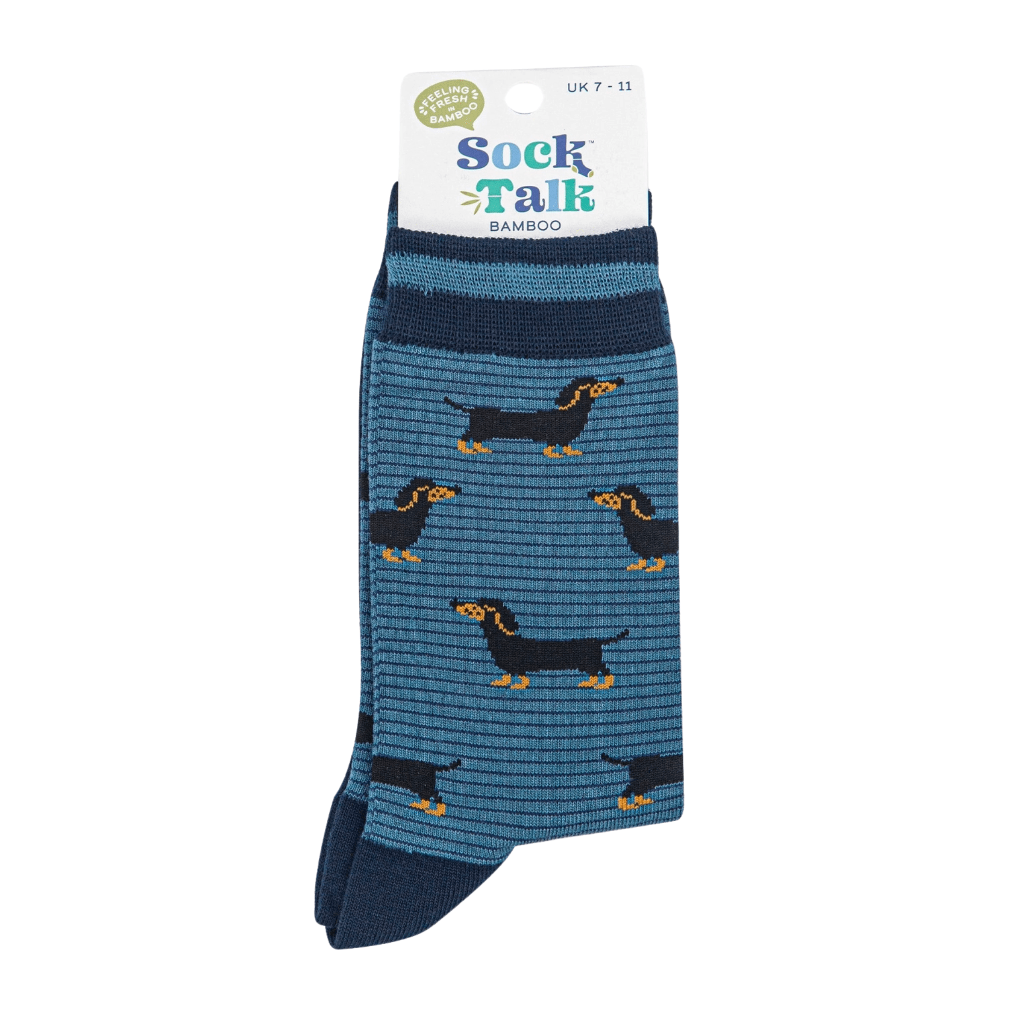 Pair of blue bamboo socks with navy cuffs and heels, featuring a repeating pattern of small black and tan dachshunds.