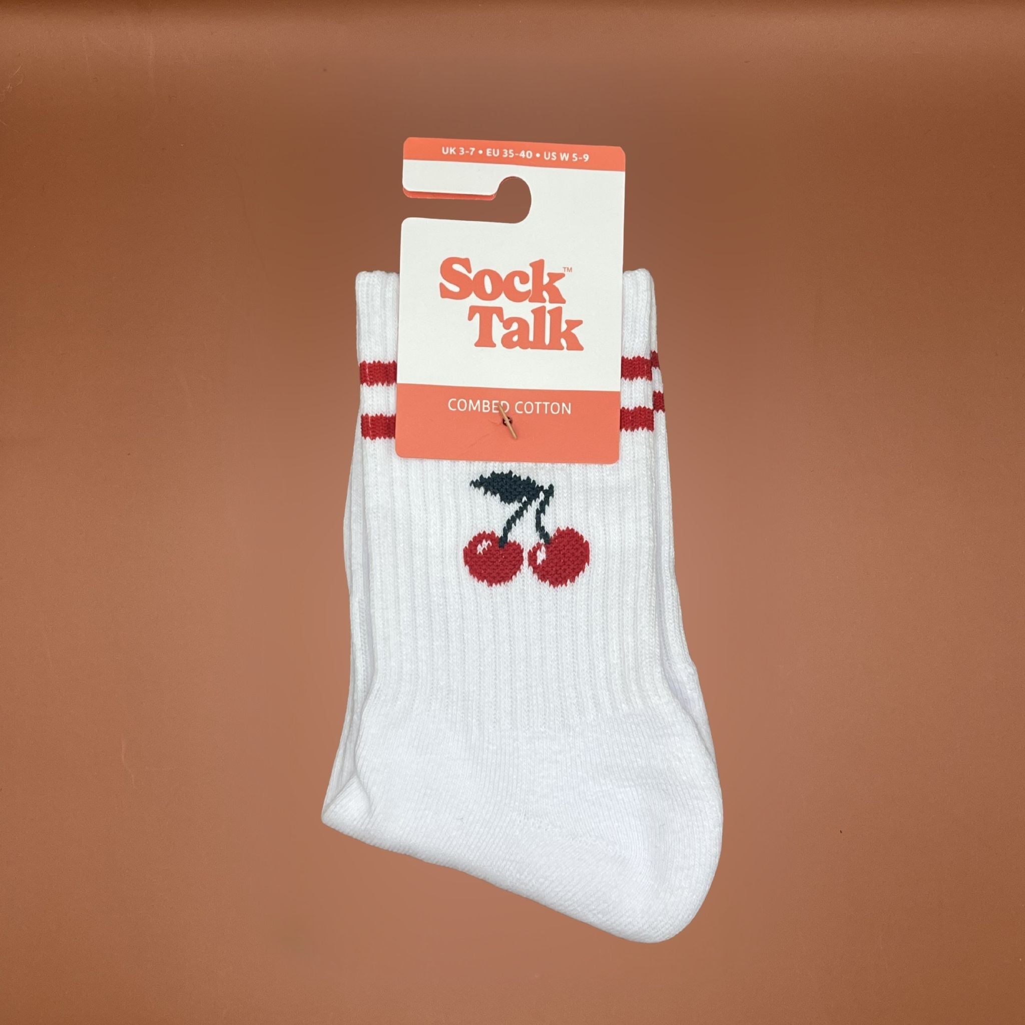 White socks with red cherries and 'Sock Talk' packaging