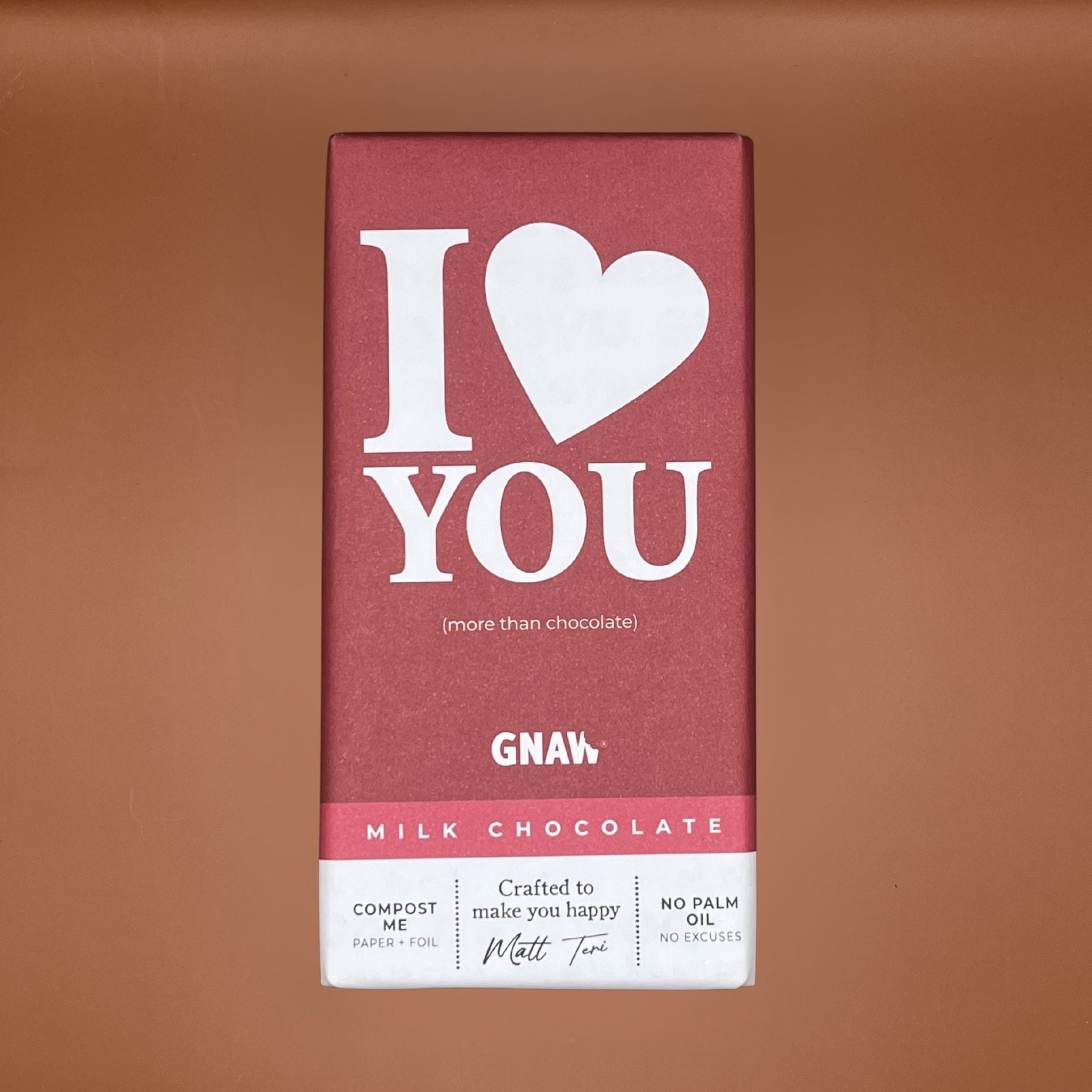 Milk chocolate bar with 'I love you' text on a brown background
