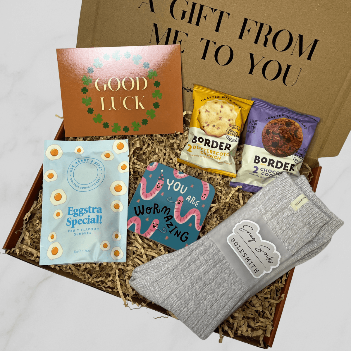Letterbox gift box with grey socks, Border biscuits, gummies, coaster and good luck card.