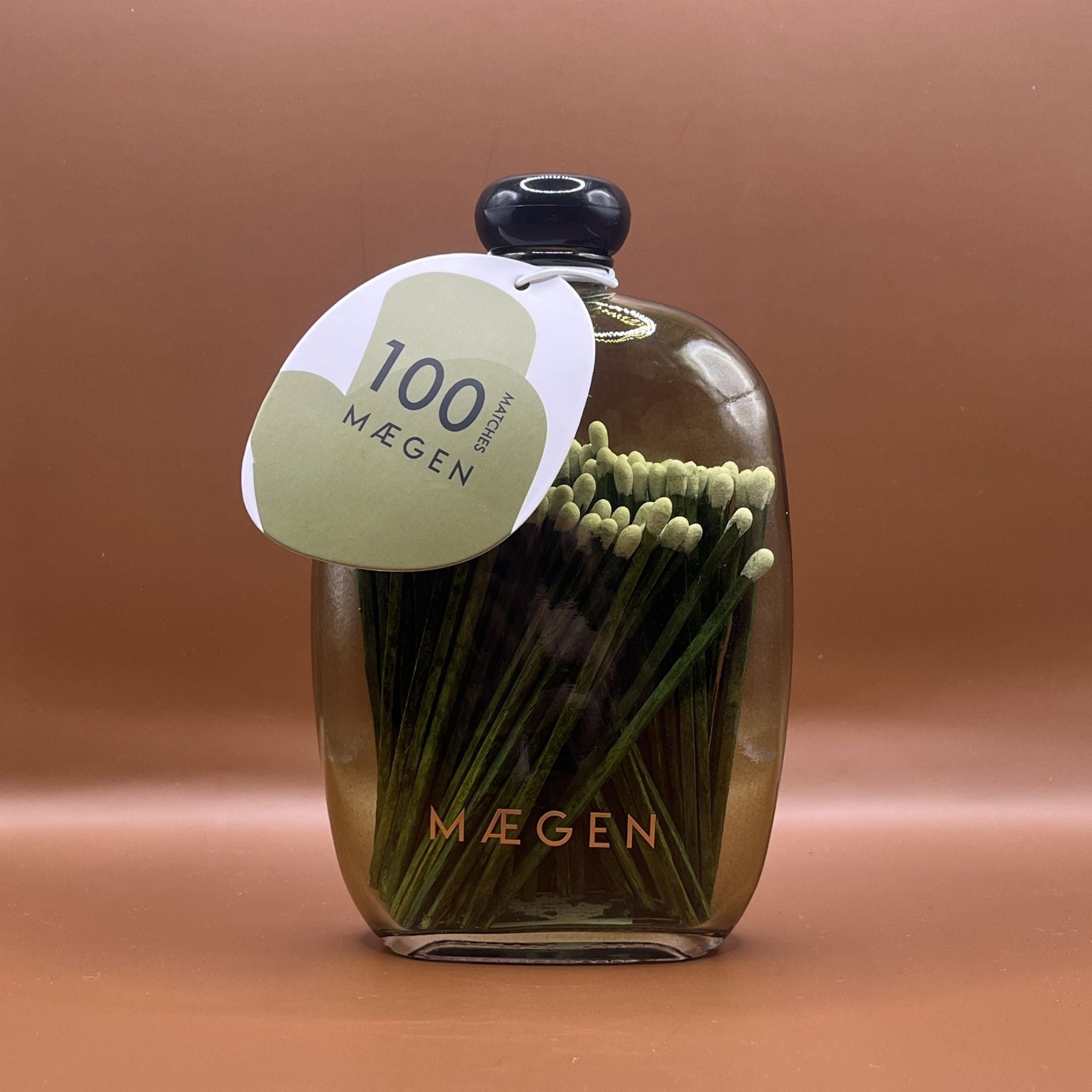 Green glass Maegen bottle with green matches inside