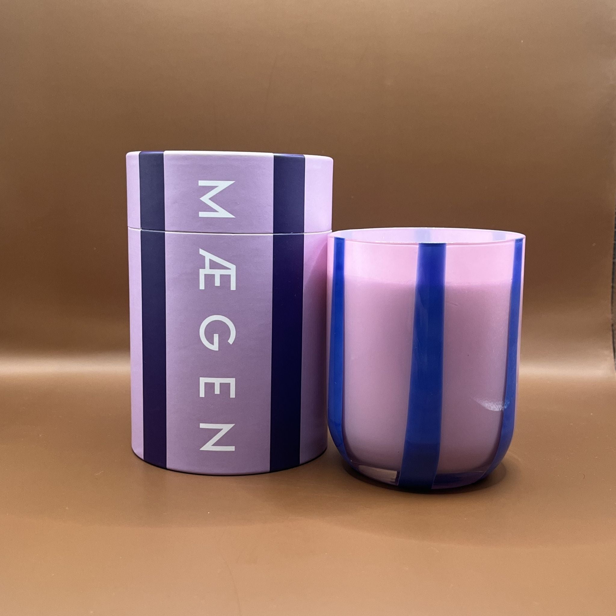 Purple cylindrical container with 'Maegen' branding purple striped candle