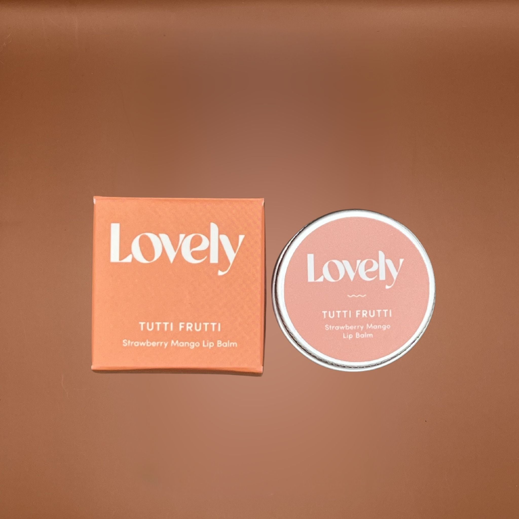 Lovely Tutti Frutti lip balm packaging on a brown background