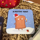Coaster with a festive toast design on a bed of brown paper shreds.