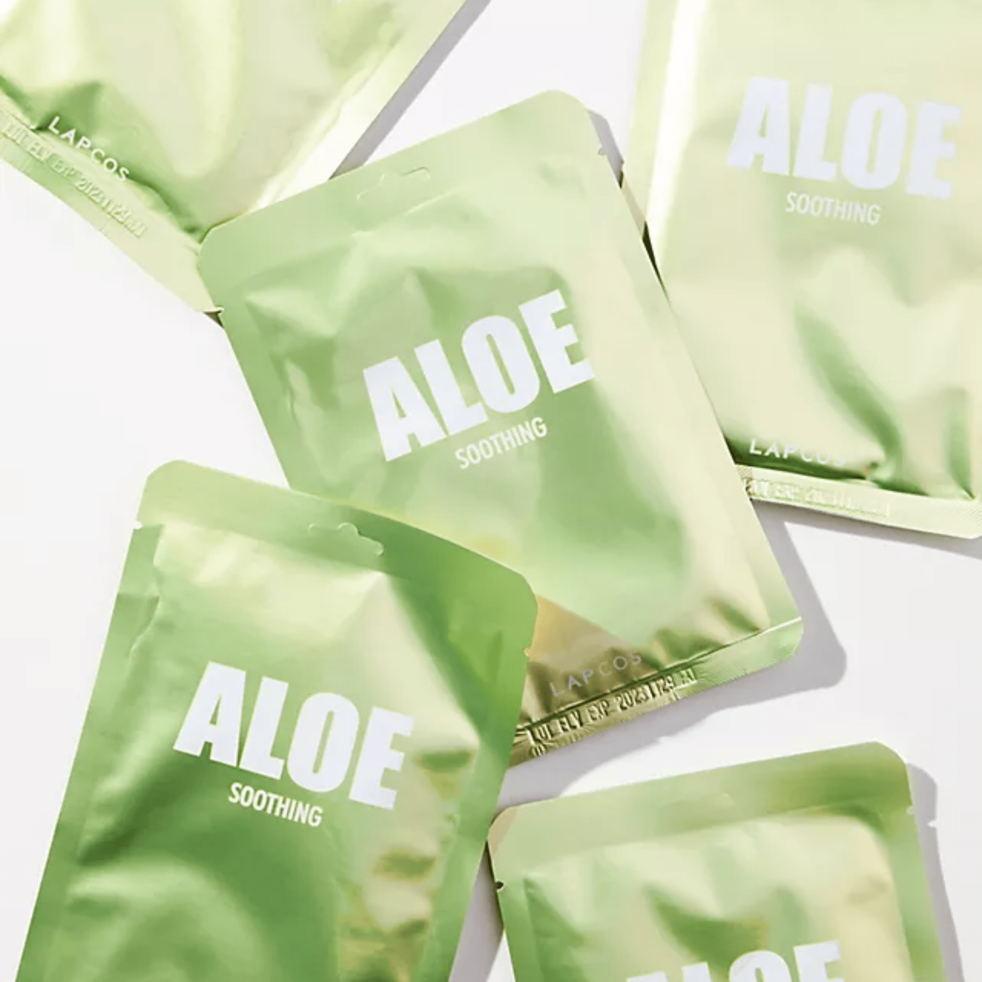 Green aloe vera packets with 'ALOE SOOTHING' text on a white background