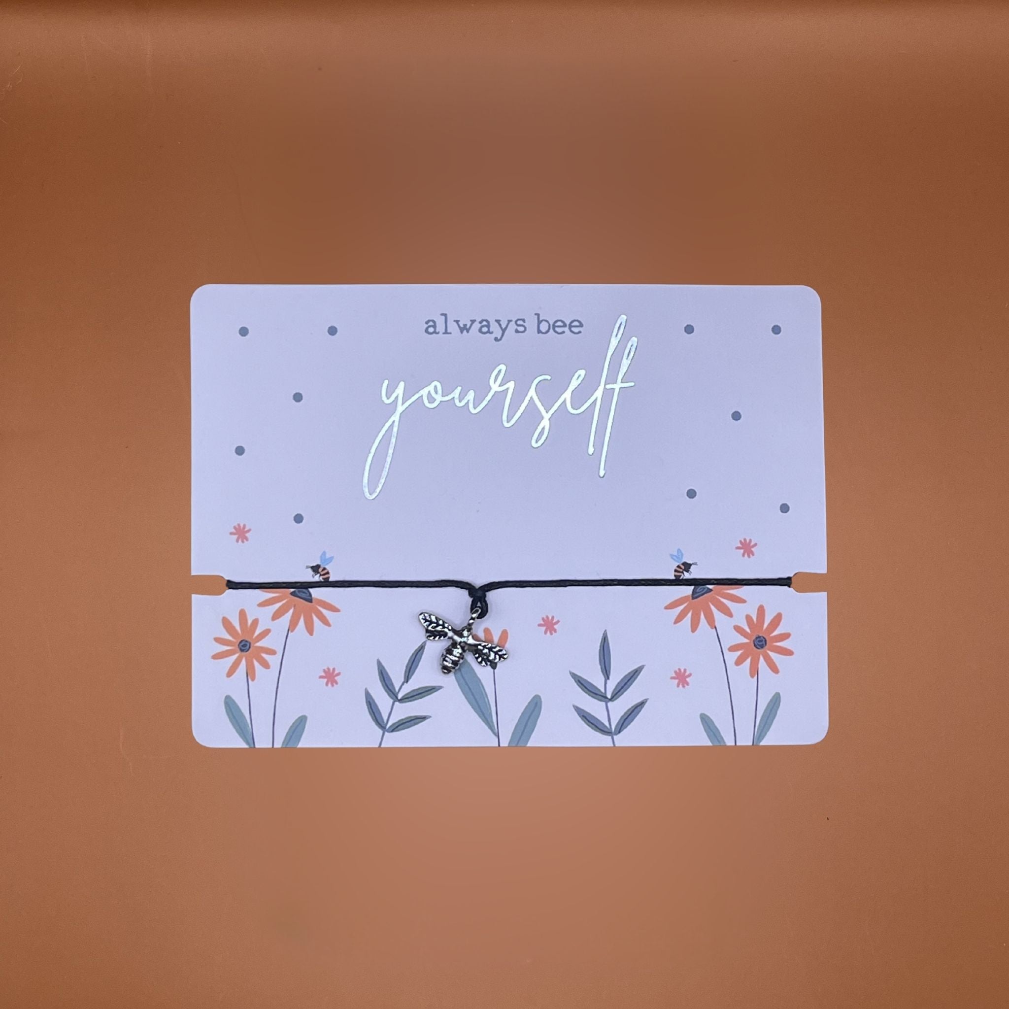 Bracelet with a bee pendant on a card with text saying 'always bee yourself'