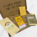 Letterbox gift box containing a rainbow notepad, honey face mask, Gnaw milk chocolate bar, and a “Be a Pineapple” wish bracelet.