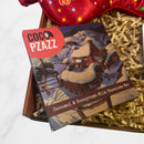 Coco Pzazz Caramel & Honeycomb Milk Chocolate Bar with winter cottage Christmas artwork, displayed in a gift box.