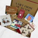 Christmas letterbox gift box containing festive reindeer socks, candy cane earrings, chocolate bar, wish bracelet, coaster, and Merry Christmas message card.