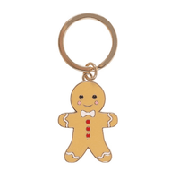 Keyring featuring a smiling gingerbread man charm with white icing details, red buttons, and a white bow tie.