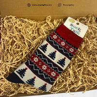 Pair of Sock Talk bamboo socks with a festive Christmas tree and snowflake pattern in red, navy, and cream tones.