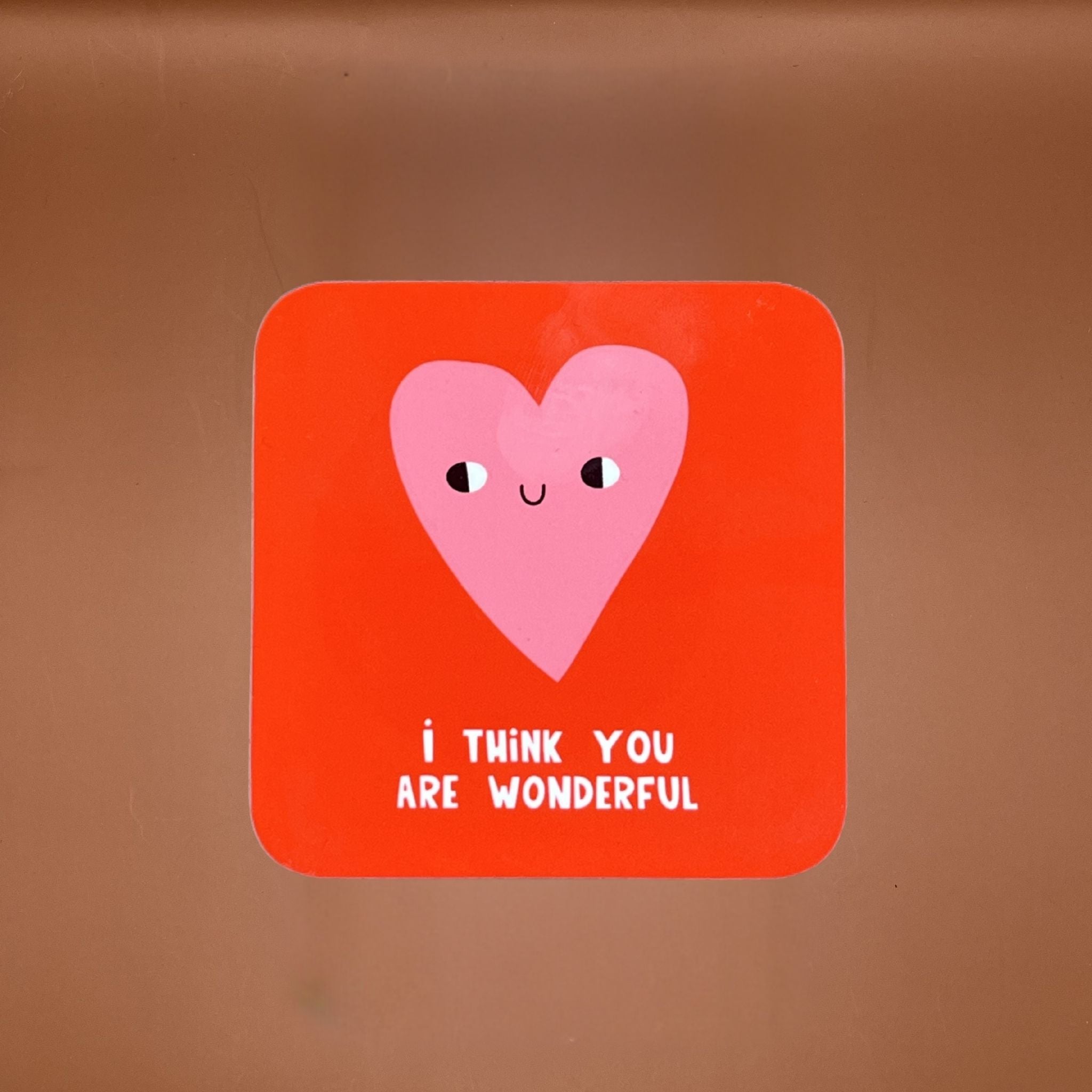 Red coaster with a cartoon love heart and text under saying 'I THINK YOU ARE WONDERFUL'