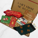 Festive Christmas letterbox gift box with gingerbread socks, red sleep mask, Santa coaster, chocolate bar, gingerbread keyring, and Christmas card.