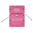 Pink card with an inspirational message with a bracelet and elephant charm.