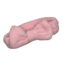 Pink fluffy headband with a bow design.