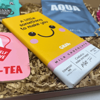Milk chocolate bar with a smiley face design and yellow branded packaging.