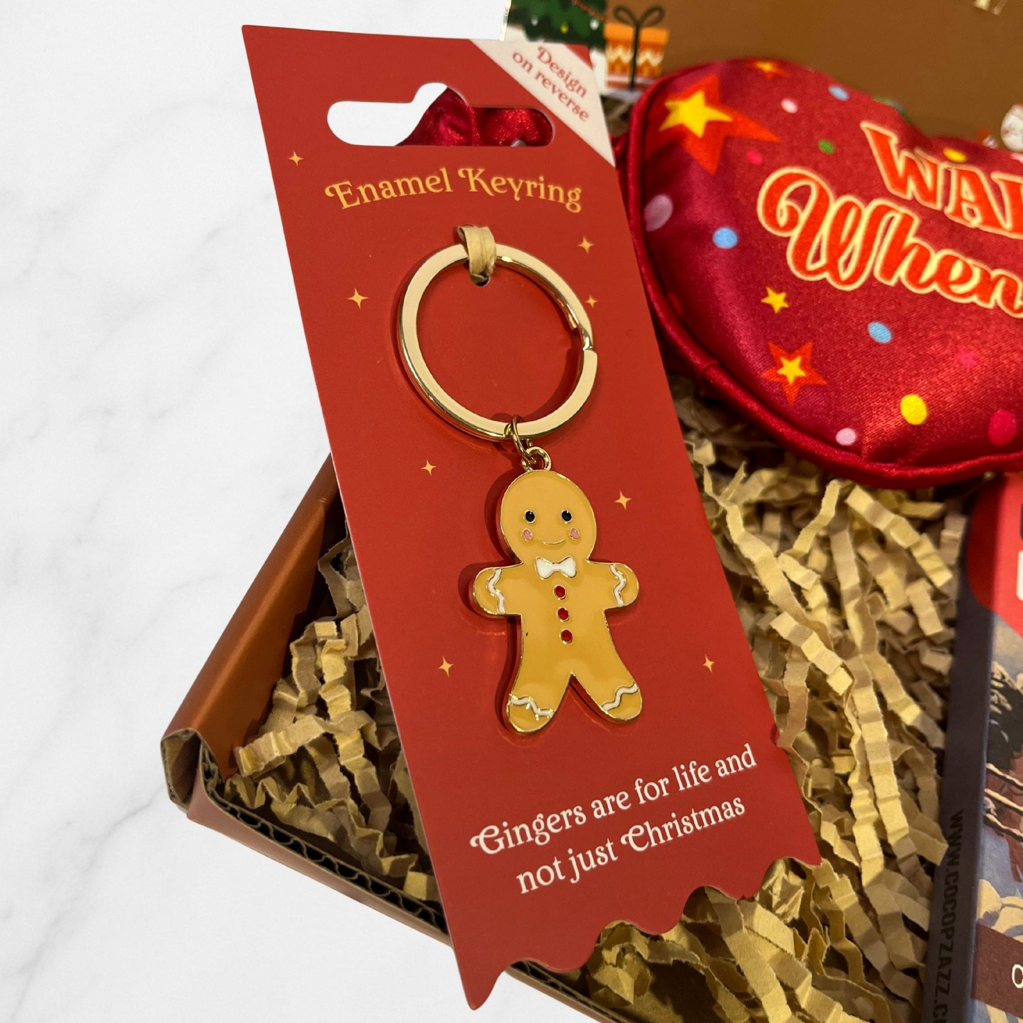 Festive enamel keyring featuring a smiling gingerbread man design on red packaging with the phrase “Gingers are for life and not just Christmas.”