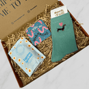 Letterbox gift box with dachshund socks, sweets and funny worm-themed coaster.