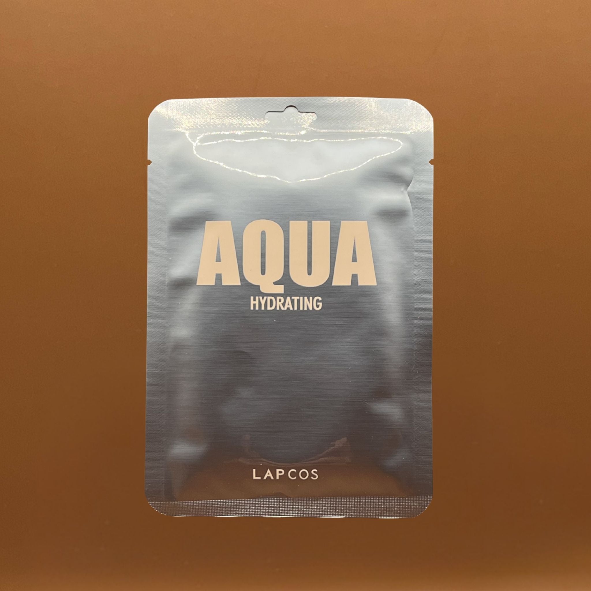 LAPCOS Aqua Hydrating packaging on a brown background