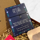“Reach for the Stars” bracelet with a small star charm on a navy backing card featuring an inspirational message