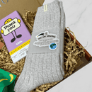 Close-up of grey You Are Amazing cosy socks inside thank you letterbox gift box.