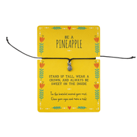 Bracelet with pineapple charm on a yellow card with text