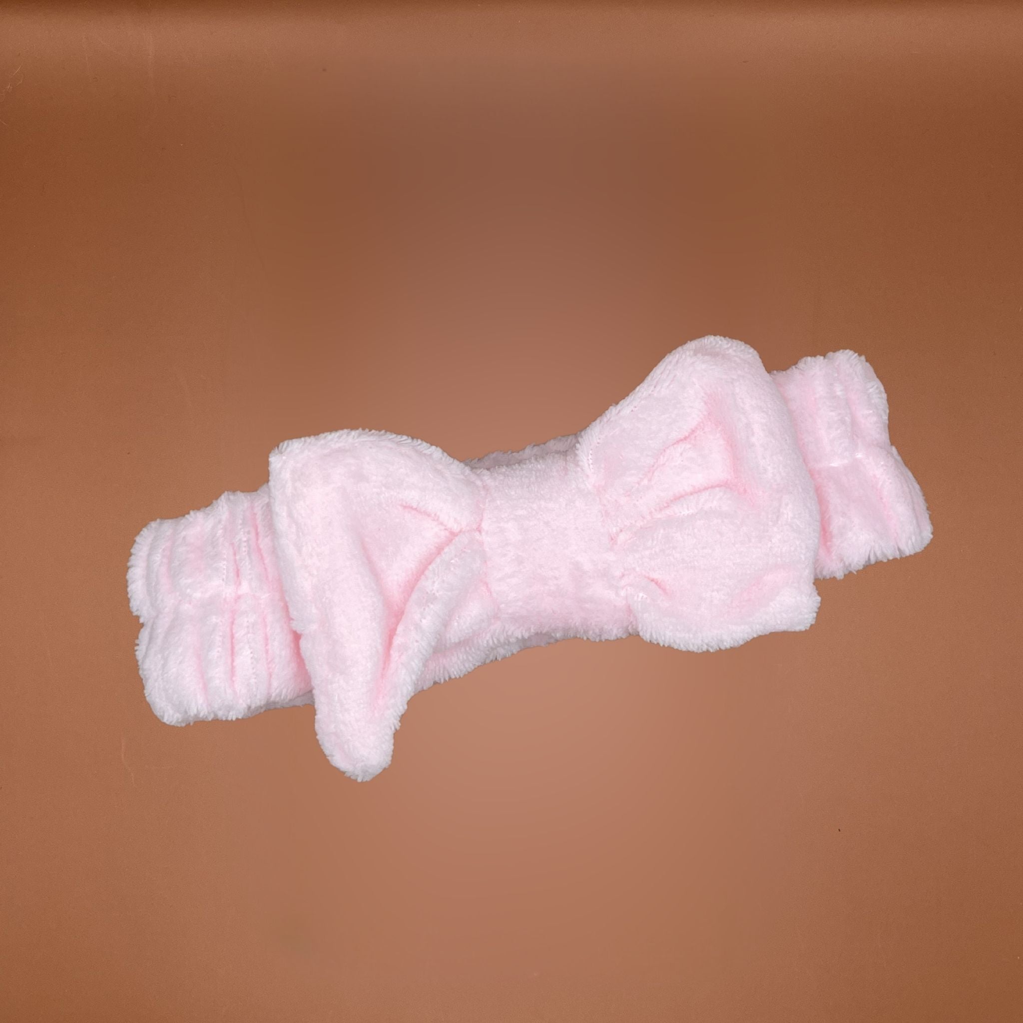 Pink fluffy headband with a bow