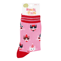 Pair of pink socks with red cuffs and toes, featuring repeating cat faces wearing party hats and crowns.