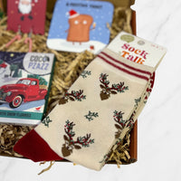 Christmas cream bamboo socks with red accents featuring a reindeer and holly design, presented inside a gift box.
