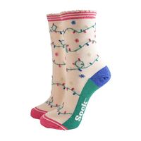 Pair of cream Christmas socks with pink toes, green heels, and glittery blue accents featuring colourful festive light string designs.