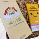 Close-up of a Dandelion Stationery notepad with a rainbow design reading “Note to self: today will be a good day.”